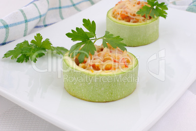 Zucchini stuffed with vegetables with rice and cheese