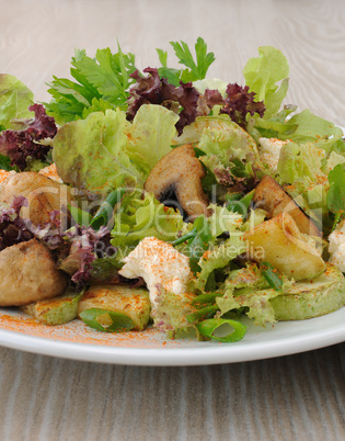Salad with mushrooms with zucchini, cheese in lettuce leaves