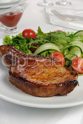 Grilled steak with vegetables on bone