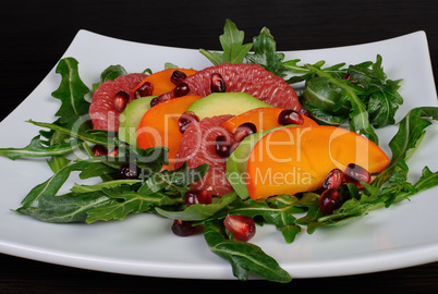 Salad with avocado, grapefruit, persimmon