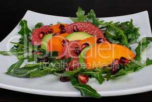 Salad with avocado, grapefruit, persimmon