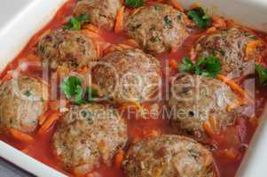 Meatballs with herbs and tomato sauce in the pan