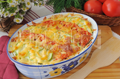 casserole of pasta with zucchini and tomato with cheese