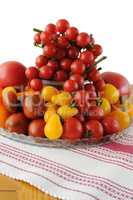 Different varieties of tomatoes in a glass vase