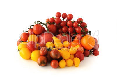 Group of different tomato varieties and colors on a white backgr