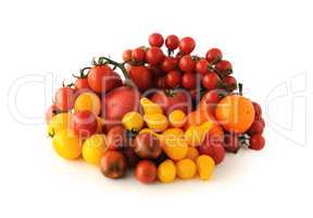 Group of different tomato varieties and colors on a white backgr