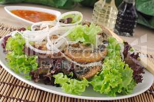 Rice noodles with mushrooms in breadcrumbs in lettuce leaves