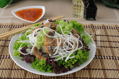 Rice noodles with mushrooms in breadcrumbs in lettuce leaves