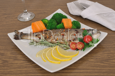Baked sea bass with broccoli and carrots