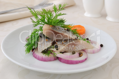 Slices of salted herring with onions and spices