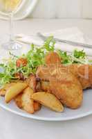 Chicken drumsticks with breadcrumbs with potatoes and salad