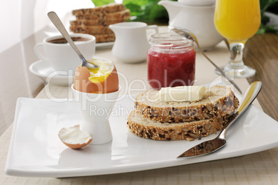 Breakfast with soft-boiled egg and slices of oatmeal bread