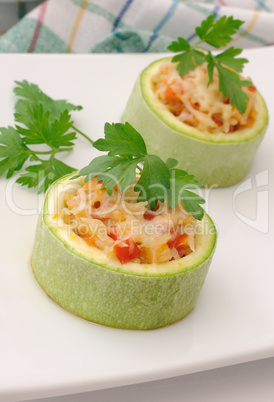 Zucchini stuffed with vegetables with rice and cheese