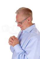 Praying senior man with folded hands.