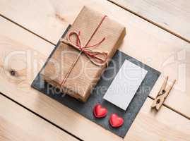 Gift box with white blank tag and hearts.
