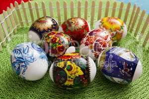 Multi-colored Easter eggs on a green background