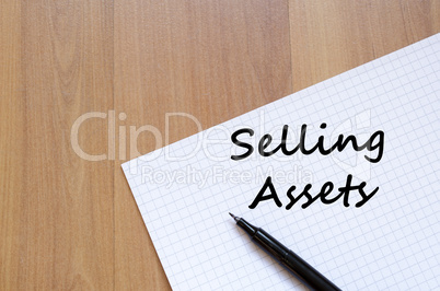 Selling assets write on notebook