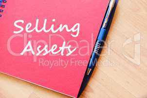 Selling assets write on notebook