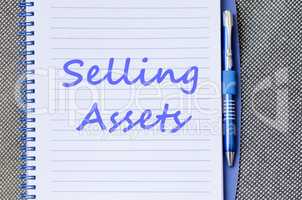 Selling assets write on notebook