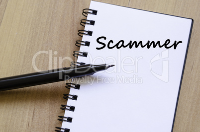 Scammer write on notebook