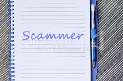 Scammer write on notebook