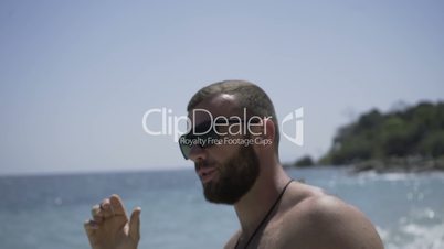 Handsome man is on the beach.