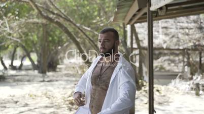 Handsome man is on the beach.