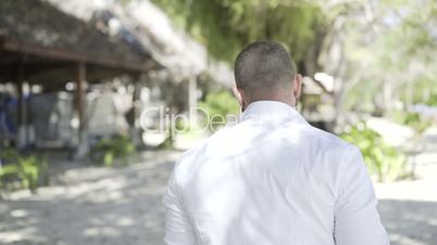 Handsome man is on the beach.