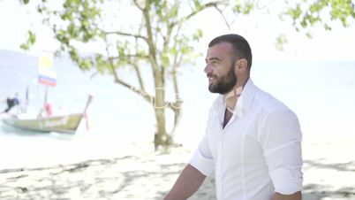 Handsome man is on the beach.