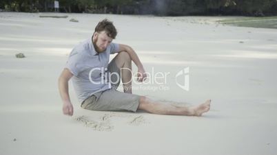 Man on the beautiful beach with a white sand.