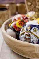 Multi-colored Easter eggs in a wooden bowl