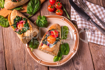 farmer baguette filled with egg, bacon and spinach