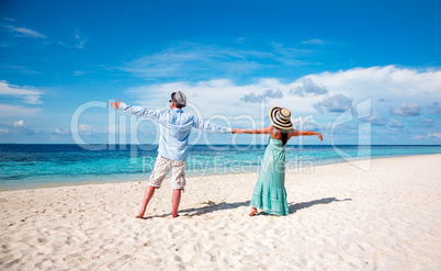 Vacation Couple walking on tropical beach Maldives.