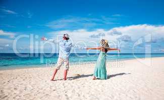 Vacation Couple walking on tropical beach Maldives.