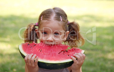 beauty little girl eat watermelon