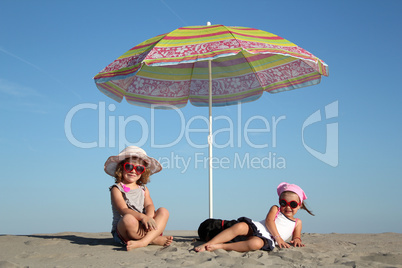 two little girl under sunshade