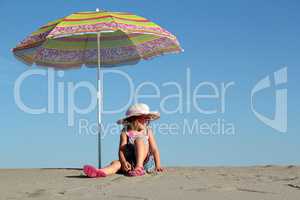 little girl with sunglasses sitting under sunshade