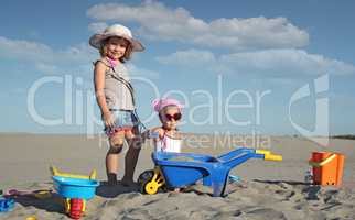 two little girl fun and play in sand