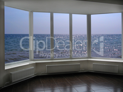 big office windows with view of marine waves