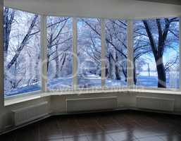 windows overlooking the winter road with trees in hoarfrost