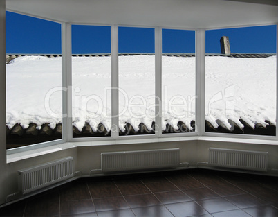 windows overlooking the snow-covered rural roof