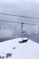 Chair lift at gray evening