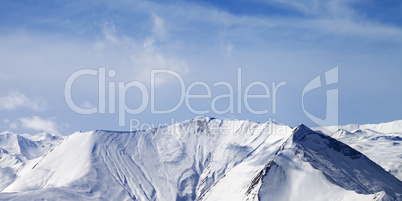 Panoramic view on snowy mountains with avalanches