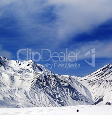 Winter mountains and blue sky with clouds