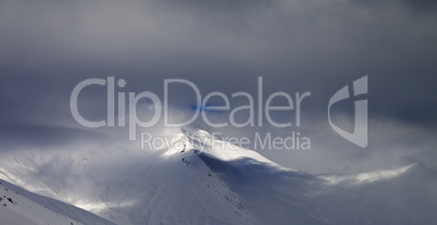 Panoramic view on off-piste slope in storm clouds