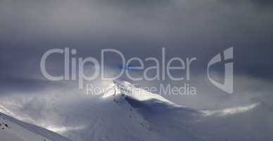 Panoramic view on off-piste slope in storm clouds