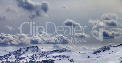 Panoramic view on mountains in evening and cloudy sky