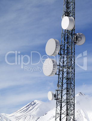 Satellite dishes in snowy mountains at sun day
