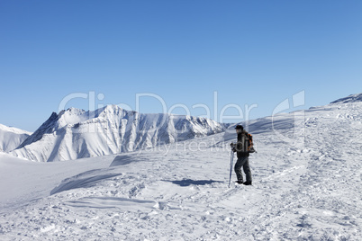 Skier on top of ski slope at nice morning