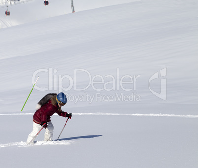 Little skier on off-piste slope with new fallen snow at nice sun
